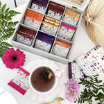 Sélection d’infusions FitClem en sachets autour d’une tasse de thé, dont Boost’Day et Drain’Night.
